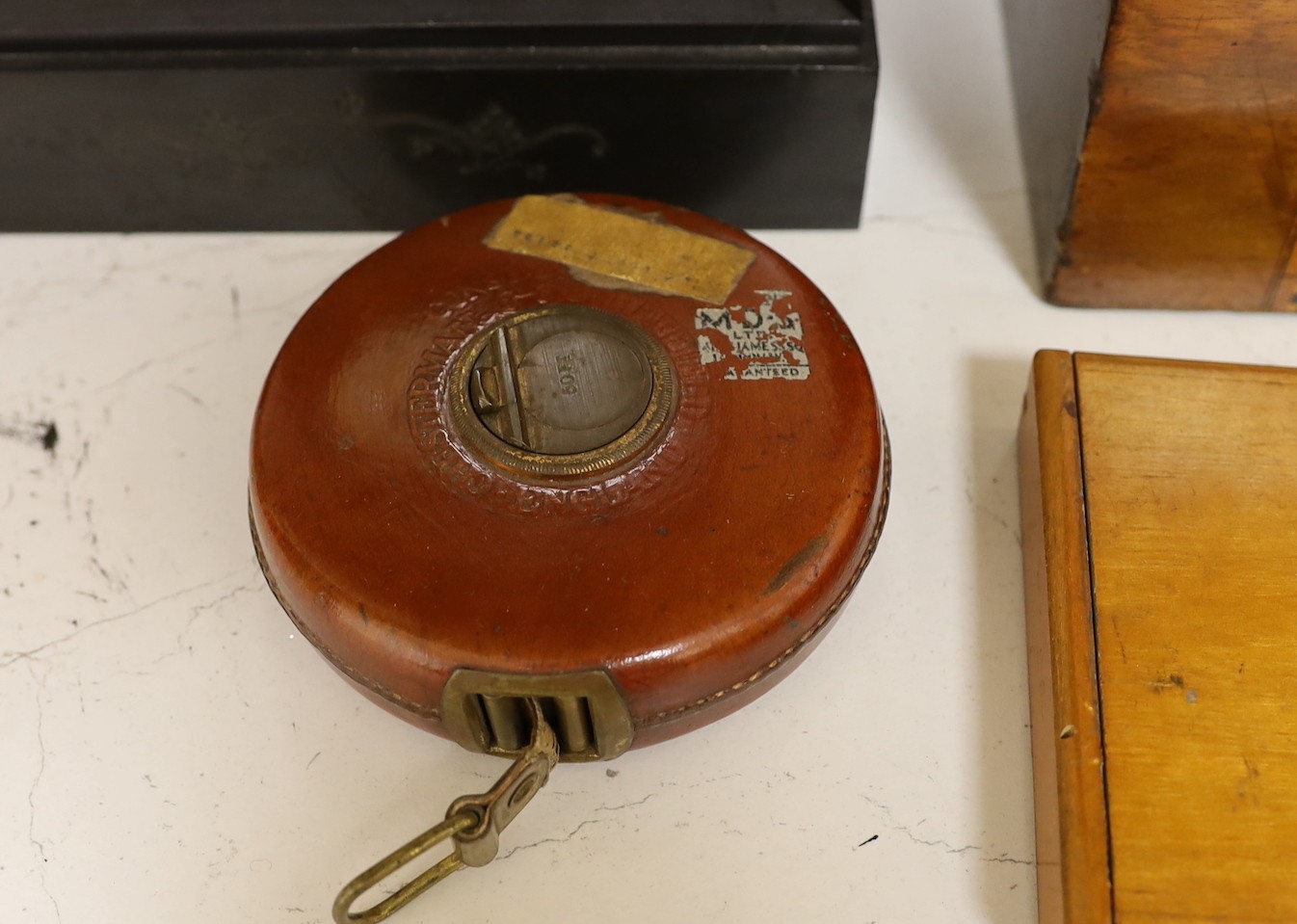 A Victorian black slate mantel clock, a parquetry writing box, a surveyor's measure, a cased French painter's set and various locks and keys
